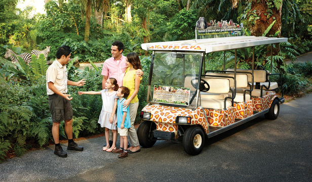 Family readies for Singapore Zoo adventure, conversing with instructor, eager to explore captivating wildlife wonders and create lasting memories.